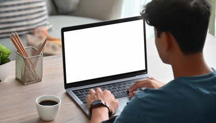 Over shoulder shot of a young man using computer laptop in front of an blank white computer screen in home