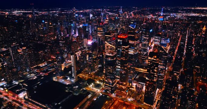 Amazing neon illumination of skyscrapers in New York downtown at night. Beautiful metropolis scenery from aerial perspective.