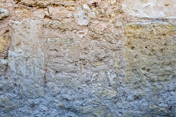 Eroded beige limestone, close up, texture, can be used as a background