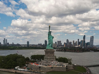 Fototapeta premium The Statue of Liberty over the Panorama of New York cityscape. Symbol of USA. New York city skyline with statue of liberty. The statue of Liberty and Manhattan. Symbol of NYC.