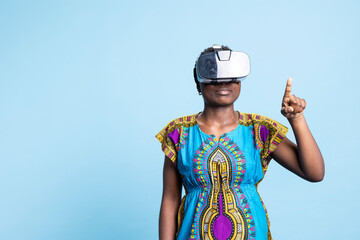 African american modern girl uses vr glasses with artificial intelligence tech, enjoying interactive 3d virtual reality headset. Cheerful person using futuristic innovation device.