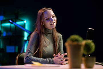 Smiling girl filming herself discussing topics of interest for generation Z audience watching her online social media content. Happy influencer recording video targeting gen Z viewers