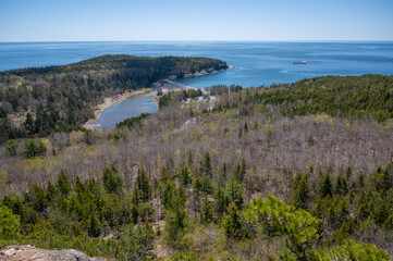 Coastal View From Beehive Mountain. A view from atop  Mountain in Acadia National Park, Maine, showing the rugged coastline, forested hills, and a small inlet. The ocean stretches out in the distance