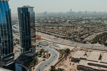 Urban city view with a highway and skyscrapers on the background of blue sky