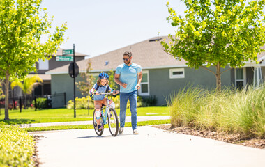 father setting a example for fathers son. fathers parenting with son outdoor. childhood of son supported by fathers care. father and son on bicycle at fathers day. Quality time between dad and kid.