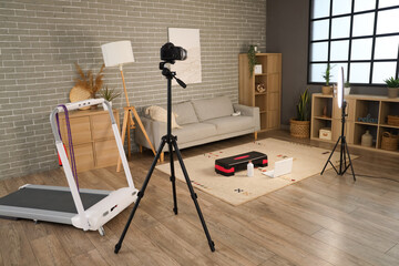 Interior of sports blogger's living room with sofa and equipment
