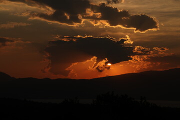 sunset behind clouds