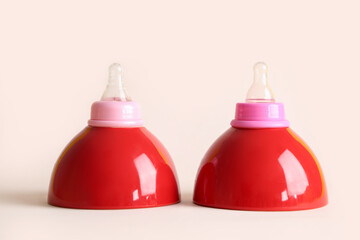 Ceramic bowls and baby bottle nipples on color background. Breast feeding concept