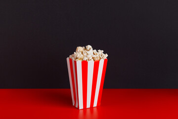 Striped box with popcorn on a red and black background