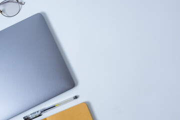 Flat lay photo of office desk with laptop,  pen, and notebook with copy space background. Mockup