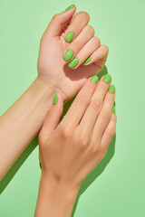Womans hands with green manicure close up. Beauty treatment spa body care
