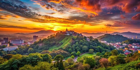 Vibrant cityscape at dusk, showcasing a tranquil hill with lush greenery, overlooking a breathtaking sunset with warm orange and pink hues.