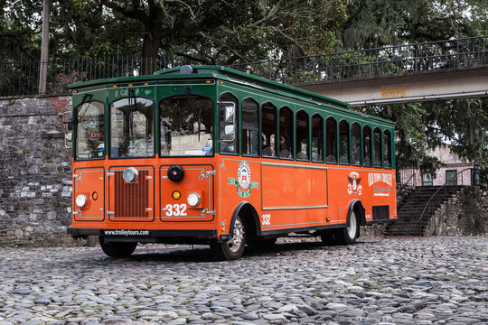 SAVANNAH, GA - JULY 21: A trolley is parked on the cobblestone riverfront in Savannah Georgia's historic district. Photo taken July 21, 2013.