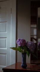 Purple Hydrangeas Flowers in Blue Vase on Wooden Table