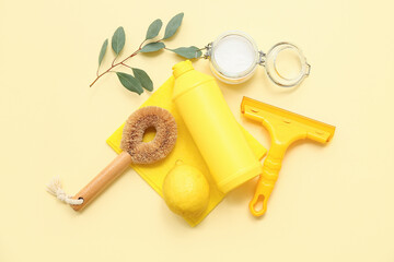 Set of natural cleaning supplies with brushes on color background