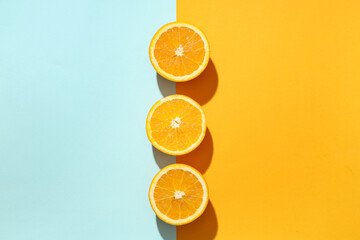 Composition with ripe tasty halves of oranges on color background