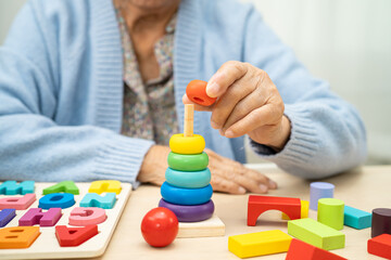 Alzheimer disease AD, Asian elderly woman patient suffering from dementia learn practical motor...