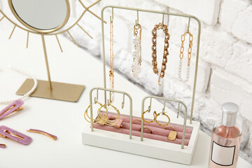 Organizer with different stylish jewelry on dresser, closeup