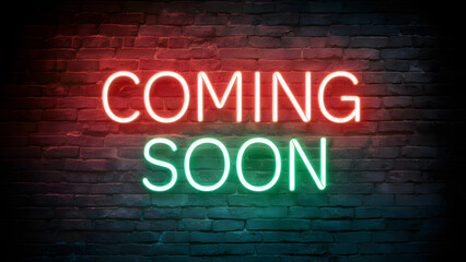 A neon sign against a brick wall backdrop. The sign is illuminated in vibrant shades of red and green, with the words 'COMING SOON' prominently displayed. The neon glow contrasts sharply with the dark