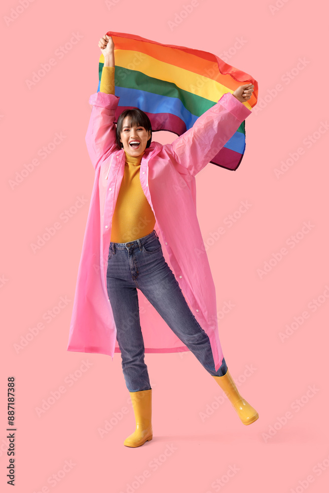 Wall mural happy young woman with lgbt flag on pink background