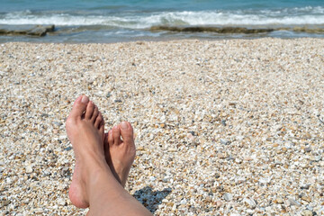 Female feet on the beach
