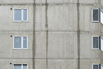 wall of a panel house with new windows. Multi-apartment buildings before insulation.