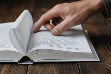 Naklejka premium Close-up of a hand flipping through the pages of an open book, emphasizing reading, learning, and exploring literature.