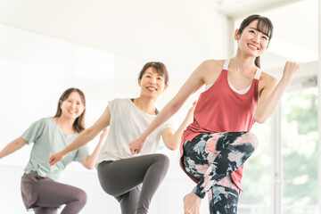 スポーツジムでダンス・エアロビレッスンをする女性達
