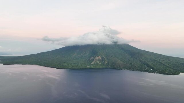 A serene dawn illuminates the scenic volcano of Lewotolok on island of Lembata, Indonesia. This beautiful and biodiverse area is part of the famed Ring of Fire and is volcanically active.
