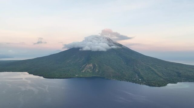 A serene dawn illuminates the scenic volcano of Lewotolok on island of Lembata, Indonesia. This beautiful and biodiverse area is part of the famed Ring of Fire and is volcanically active.