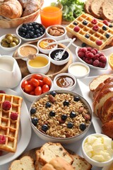 Different meals served for breakfast on white table