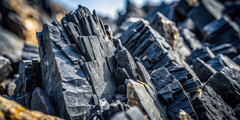 Close-up of jagged, black rocks with a rough, textured surface, rocks, black, jagged, close-up, rough, textured, surface, nature