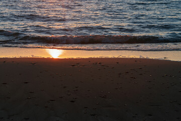 Beach sand with pebbles on the edge of the Baltic Sea at sunset, Curonian Spit, Kaliningrad region,...