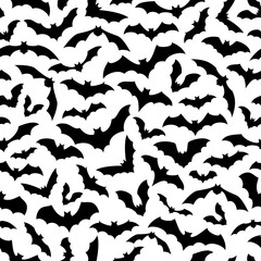 Obraz premium Halloween bats seamless pattern, a flurry of nocturnal creatures in flight, silhouetted against white background, creates a hauntingly stylish vector tile for spooky celebrations, wallpapers and decor