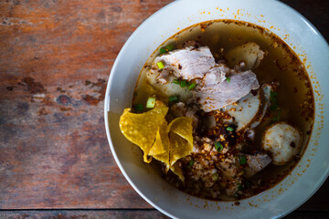 Thai noodles with pork served with crispy wontons. Traditional and famous street food in Thailand