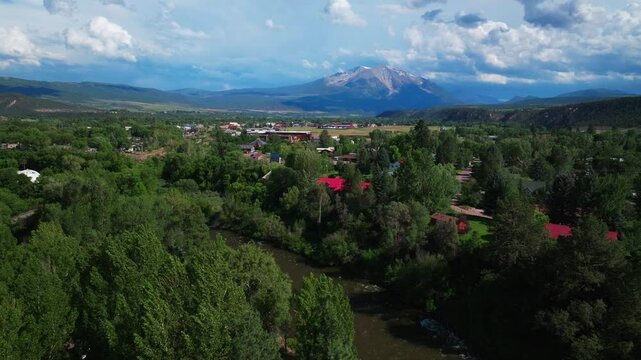 Carbondale Roaring Fork River Mount Sopris Spores Marble Basalt Aspen Snowmass summer aerial drone Colorado June July Rocky Mountain snow cap peaks Marble El Jebel clouds sunny circle right motion