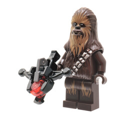 Naklejka premium Lego minifigure of Chewbacca Star Wars Character with weapon isolated on white. Editorial illustrative image of popular plastic constructor to 25 Anniversary.