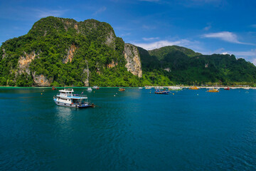 A View of floating travelers boats and beautiful sceanery at Ko Phi Phi Don in Phuket.