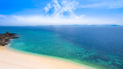 Nature of the beach and sea Summer with sunshine, sandy beaches, clear blue waters sparkling against the blue sky. On an island with good ecology and environment Background for summer vacation concept