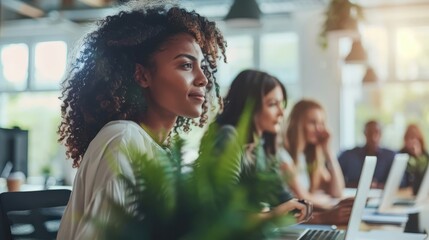 Diverse Group of Professionals Working in Modern Office with Natural Light and Greenery