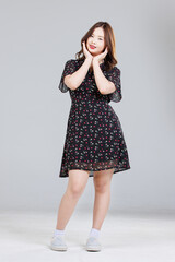 Portrait of Asian cute cheerful young girl wearing small flower pattern color black dress, stylish model woman happy and cool sweet smile posing isolated on white background, Teenage and youth fashion