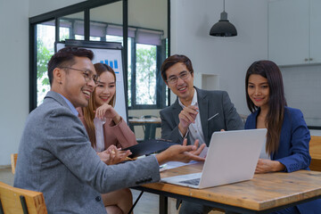 Group of business people having a meeting in a tech company. Creative business professionals planning a project in an office. Teamwork and collaboration in a modern workplace.