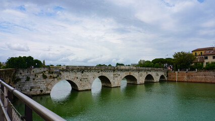 Historical roman Tiberius Bridge over Marecchia river in Rimini, Italy