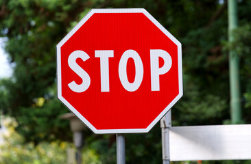 Close-up of red and white stop sign with octagon shape at Italian city of Meran on a sunny summer day. Photo taken July 16th, 2024, Meran Merano, Italy.
