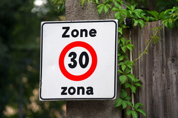Close-up of red and white road sign of Zone Zona 30 at Italian city of Meran on a sunny summer day. Photo taken July 16th, 2024, Meran Merano, Italy.