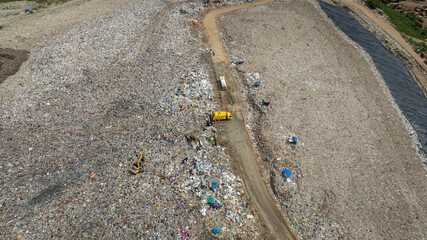 truck waste dump and backho work, Waste from household in waste landfill disposal pile plastic garbage and various trash, Environmental pollution warning.