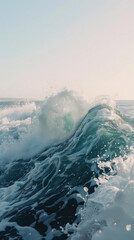 Ocean wave rising up in foamy crest against clear sky