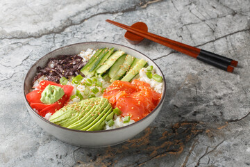 Rice sushi bowl with salmon, avocado, cucumber, green onion, seaweed, pickled ginger and wasabi...