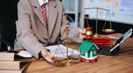 Real Estate Lawyer And House Foreclosure Law. House model, hammer judge gavel on table with white background.