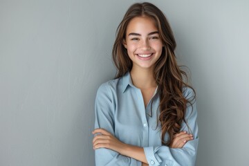 The young woman crossed her hands and looked at the camera with a smile